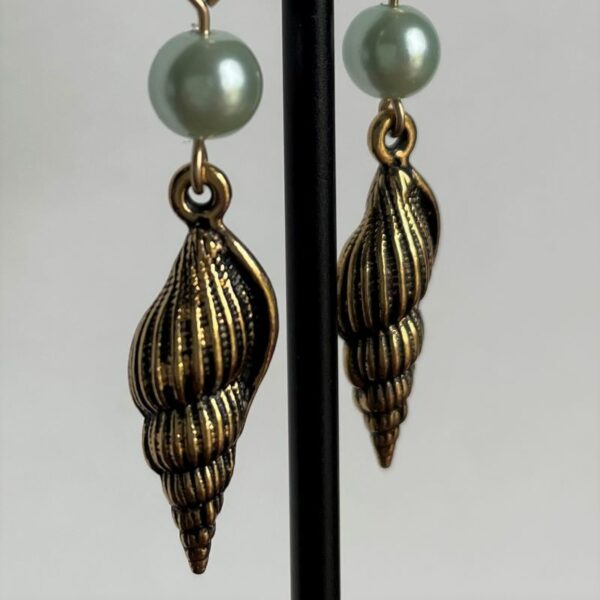 Earrings with Gold shells under light green pearl-like beads